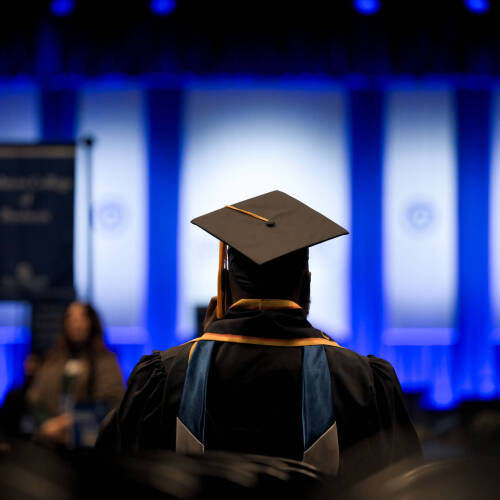 Graduate student looking towards the stage at GVSU 2025 Commencement Ceremony.
